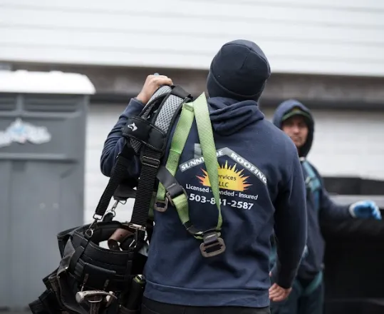 Sunnyside Roofing technician carrying safety harness