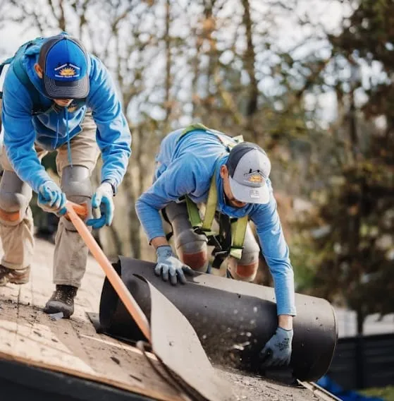 Sunnyside Roofing workers preparing underlayment during a residential roof replacement