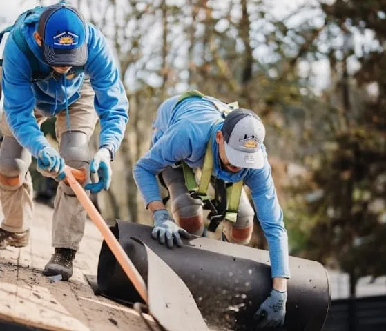 Sunnyside Roofing workers preparing materials for a roof replacement