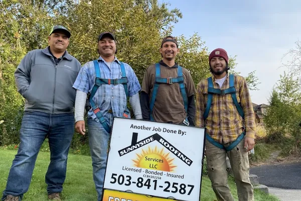Sunnyside Roofing team holding lawn sign